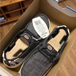 Hey Dude Women’s Black and White Cow Print Moccasins